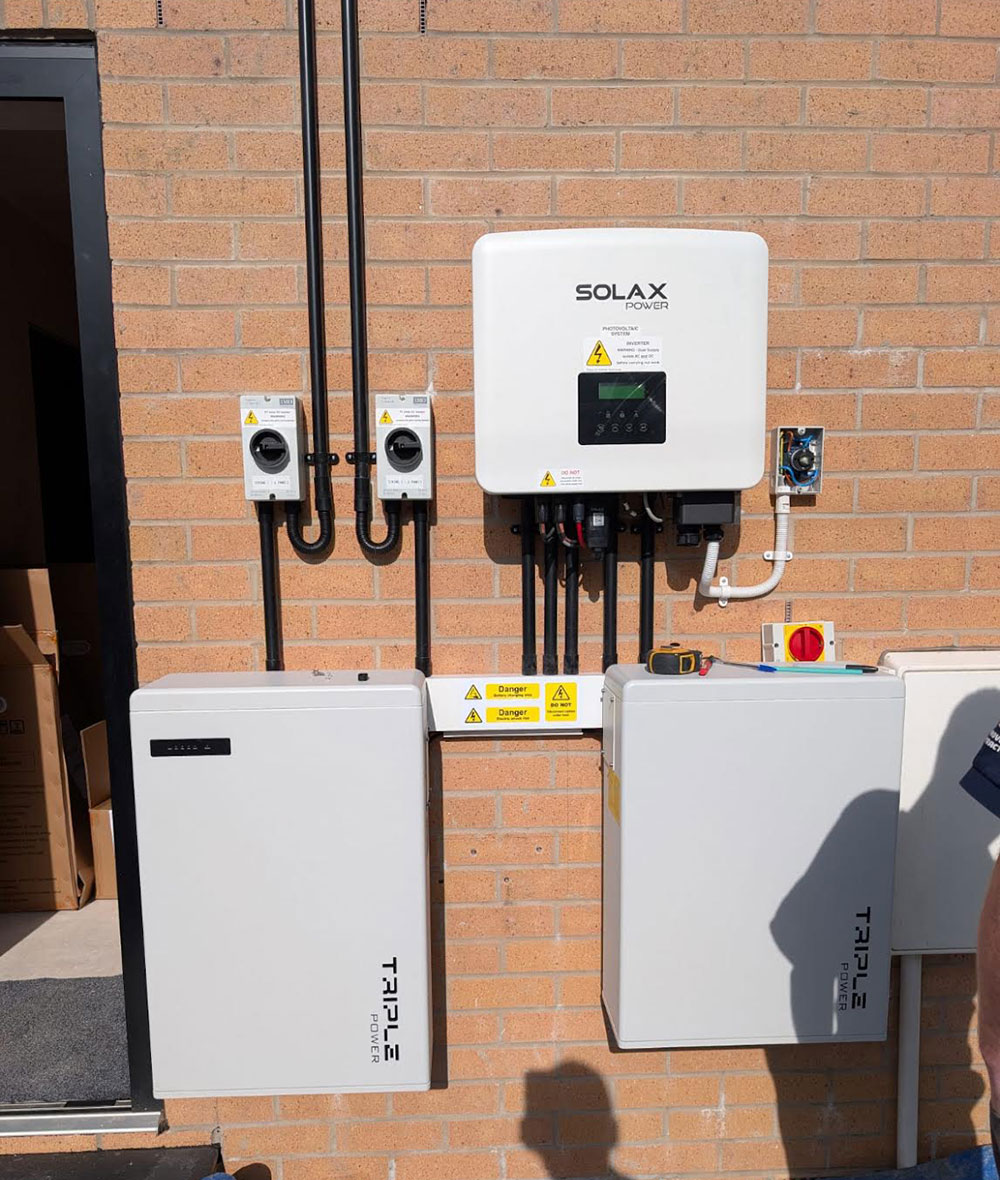 A photo of battery storage on the side of a house.